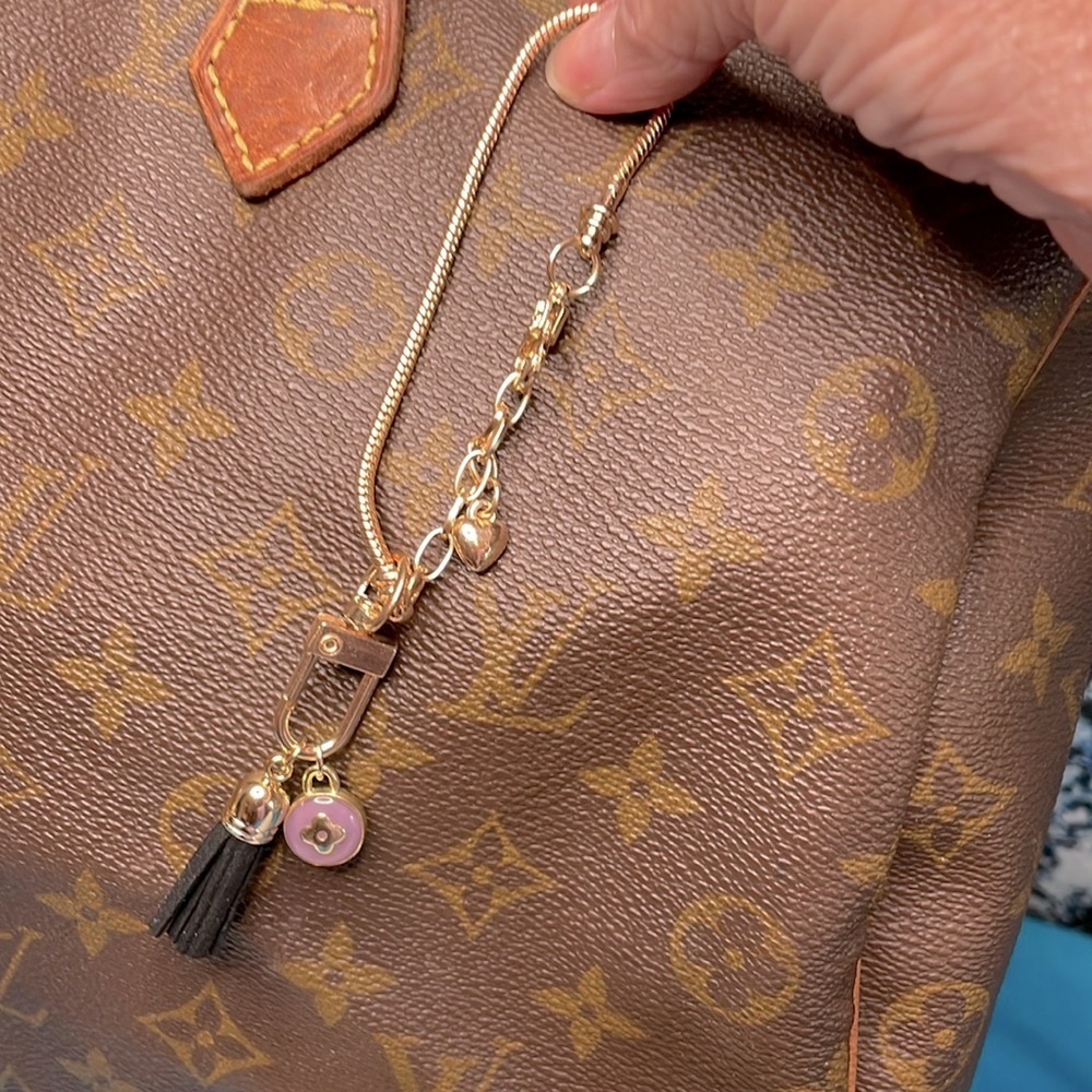 Louis Vuitton Purple & Gold “Skittle” Charm on Gold tone Bracelet w/black tassel